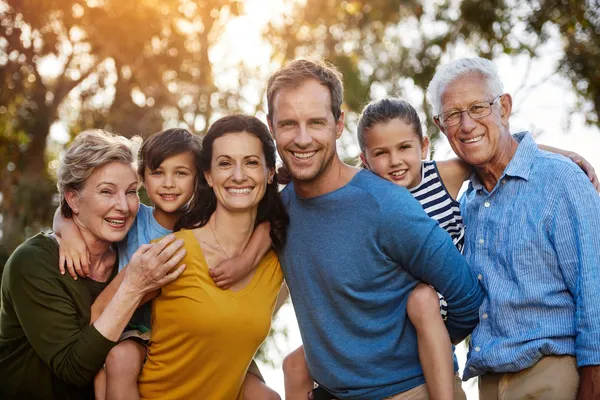 Multigenerational family smiling together outdoors